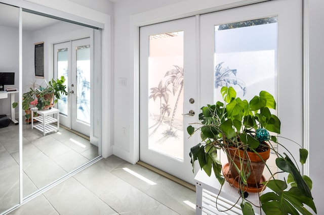 entryway featuring french doors and light tile patterned floors