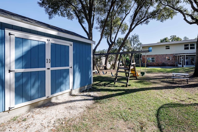 view of outdoor structure featuring a playground and a yard