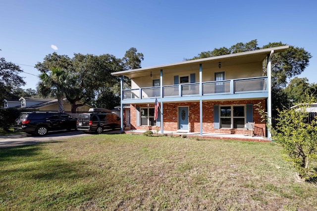 view of front of home featuring covered porch, a front lawn, and a balcony