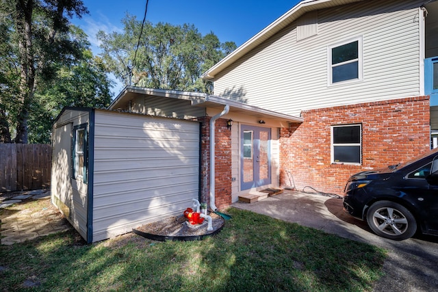 view of side of property featuring a lawn and a garage