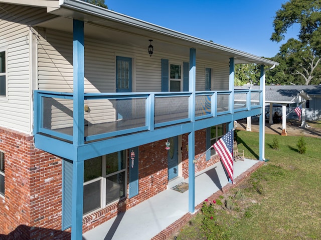 back of property featuring a lawn and a patio area