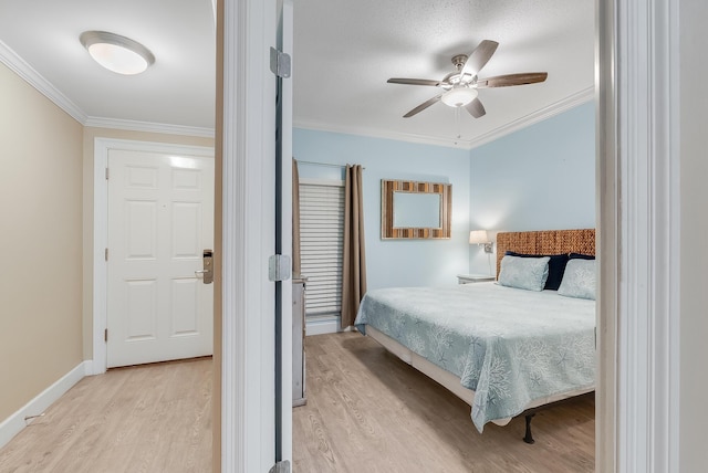 bedroom with baseboards, ornamental molding, and light wood-style floors