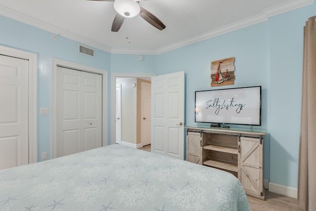 bedroom featuring ceiling fan, ornamental molding, and hardwood / wood-style floors