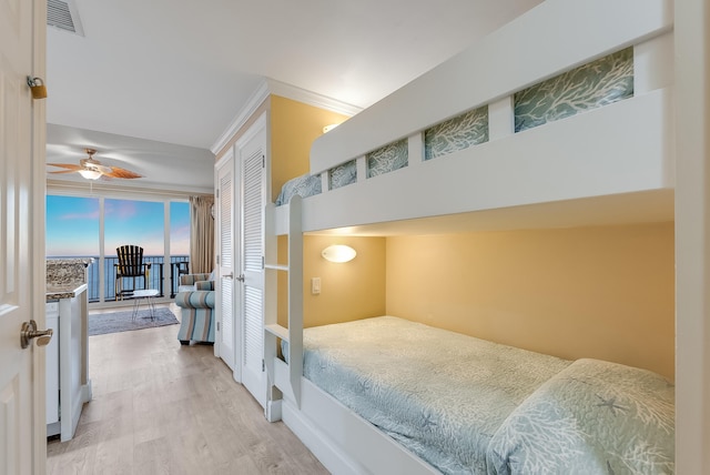 bedroom with wood-type flooring, a closet, and ceiling fan