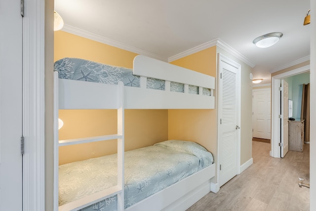 bedroom featuring crown molding and hardwood / wood-style flooring