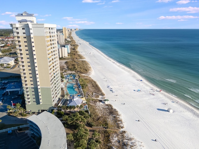 drone / aerial view featuring a water view and a beach view