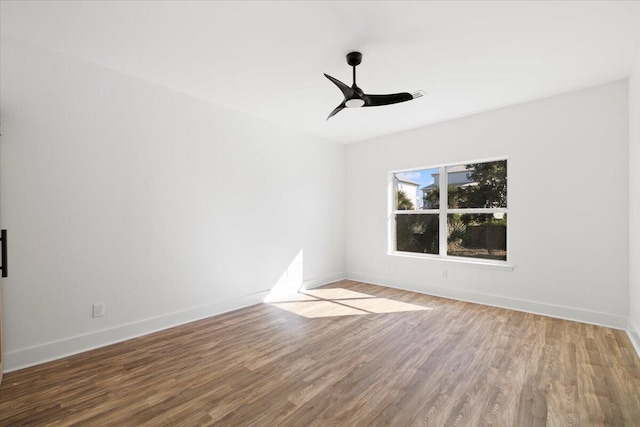 empty room with wood-type flooring and ceiling fan