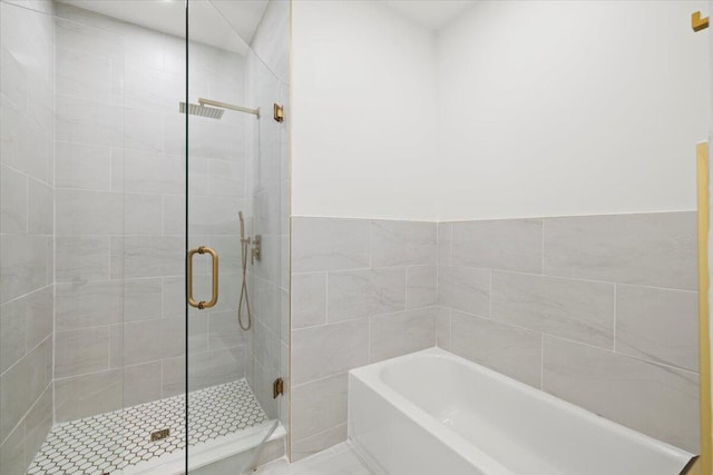 bathroom with shower with separate bathtub