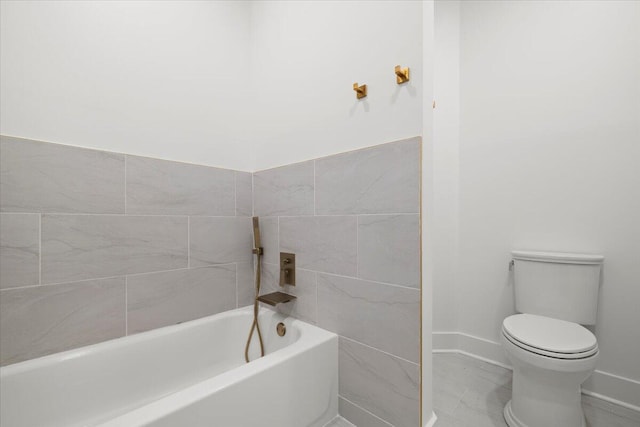 bathroom featuring toilet and a tub to relax in