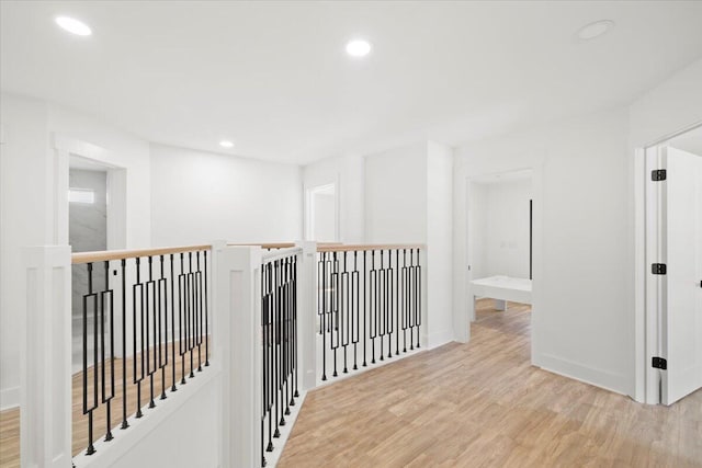 hallway with light hardwood / wood-style floors