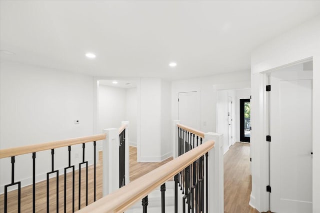 hallway with light hardwood / wood-style floors