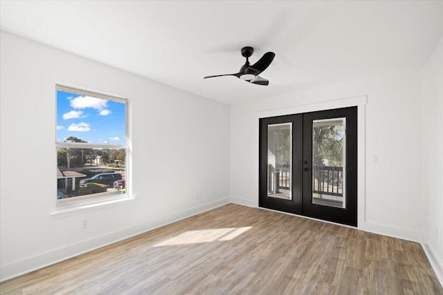 unfurnished room with french doors, hardwood / wood-style flooring, and ceiling fan