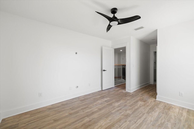 spare room featuring ceiling fan and light hardwood / wood-style flooring