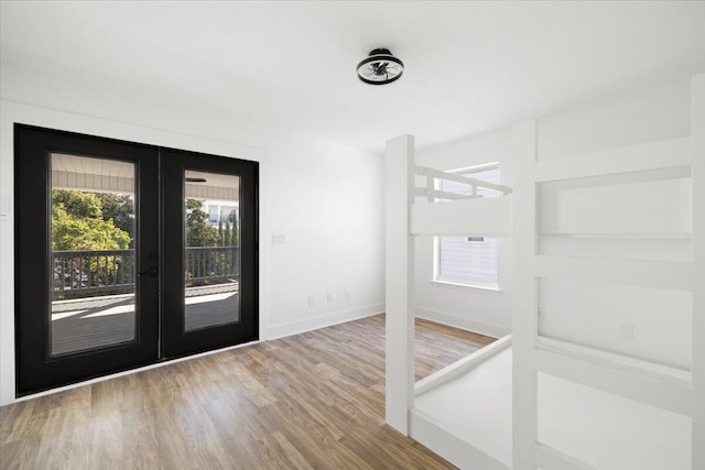 interior space with french doors and wood-type flooring