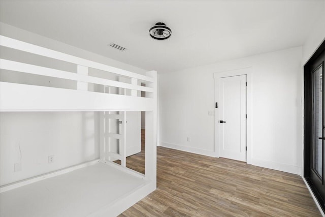 unfurnished bedroom featuring wood-type flooring