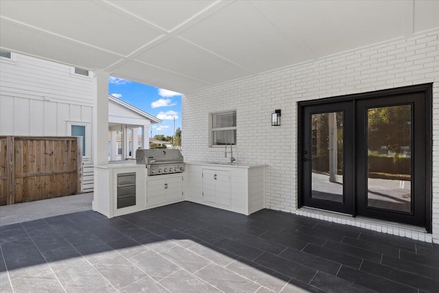 view of patio / terrace featuring sink, french doors, exterior kitchen, and a grill