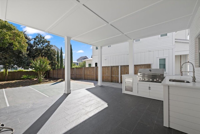 view of patio with grilling area, sink, and exterior kitchen