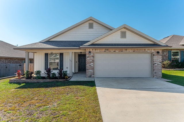 view of front of home featuring a front lawn and a garage