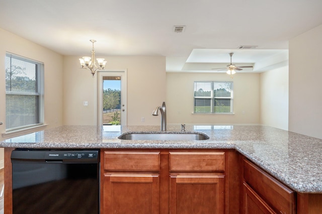 kitchen with black dishwasher, sink, light stone counters, and a raised ceiling