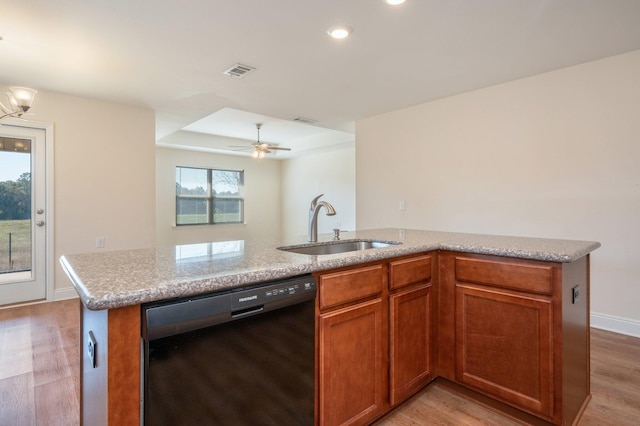 kitchen featuring black dishwasher, sink, light wood-type flooring, and ceiling fan