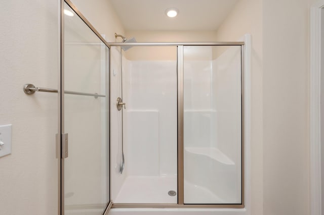 bathroom featuring a shower with door