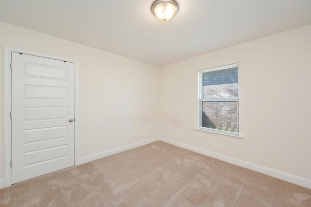 spare room featuring light colored carpet