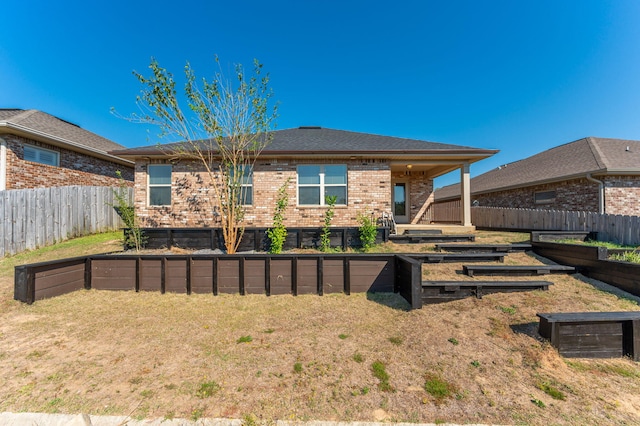 rear view of house with a lawn