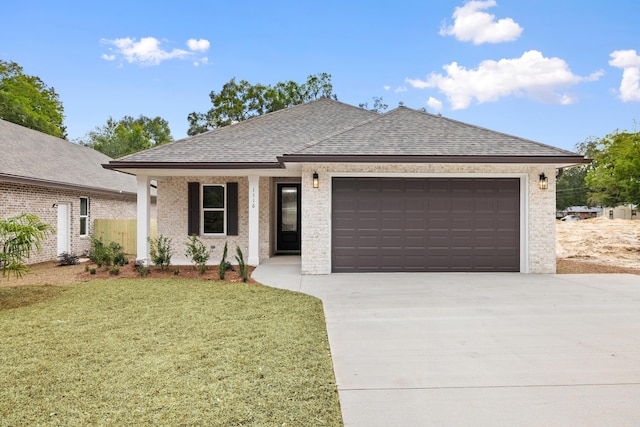 view of front of property with a front lawn and a garage