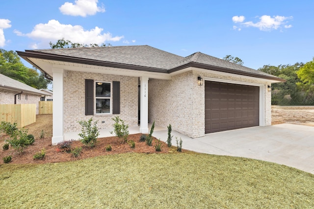 view of front of house featuring a front lawn and a garage