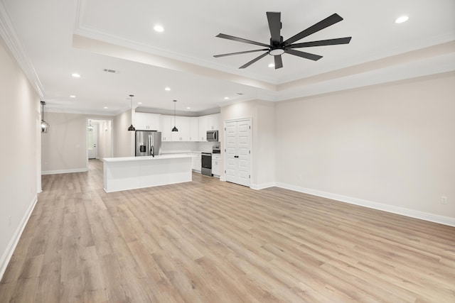 unfurnished living room with ceiling fan, crown molding, light hardwood / wood-style flooring, and a raised ceiling