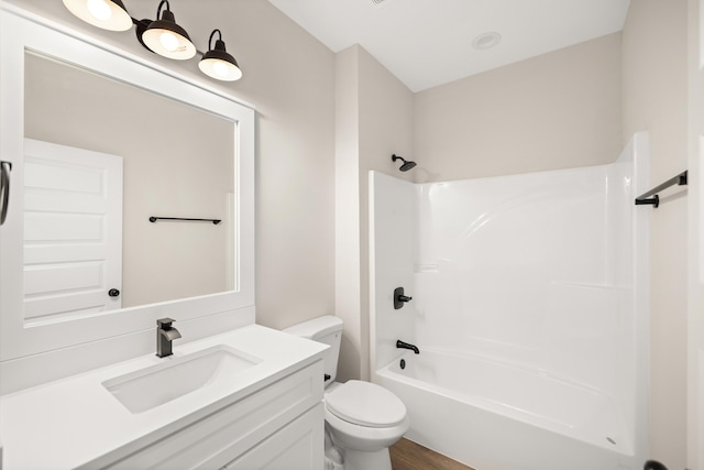 full bathroom with toilet, shower / bathtub combination, hardwood / wood-style flooring, and vanity