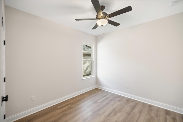 empty room with ceiling fan and light hardwood / wood-style flooring