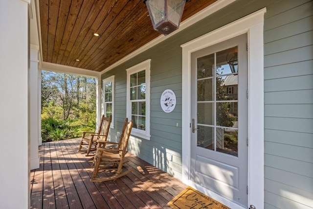 wooden terrace featuring covered porch