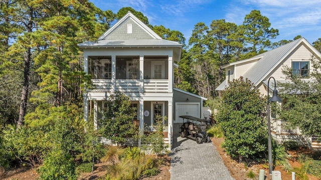 view of front of house featuring a garage and an outbuilding