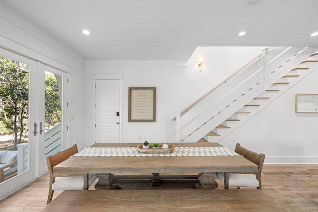 dining space with french doors and light wood-type flooring