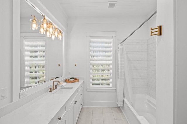 bathroom with vanity, shower / bath combination with curtain, and a healthy amount of sunlight