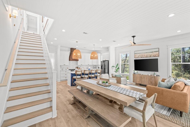 dining area with ceiling fan, light hardwood / wood-style floors, and wooden ceiling