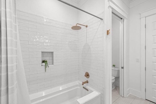 bathroom featuring shower / bath combination with curtain, toilet, and tile patterned flooring