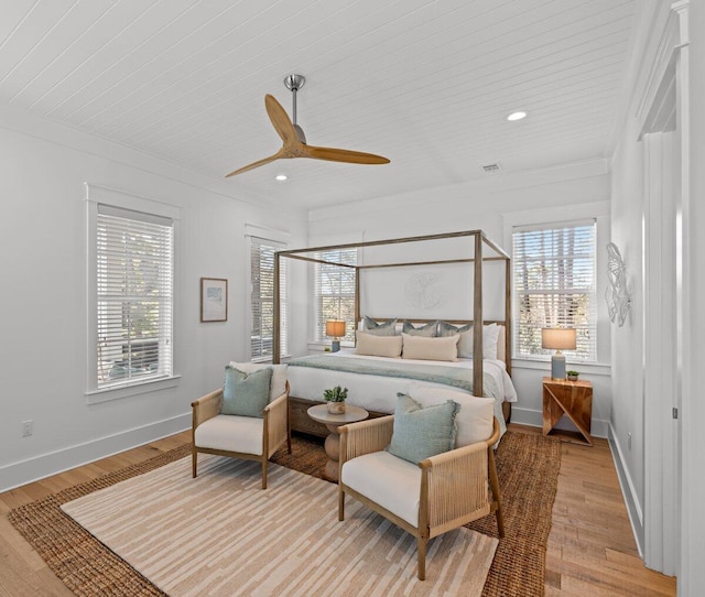 bedroom featuring ornamental molding, light hardwood / wood-style flooring, and ceiling fan