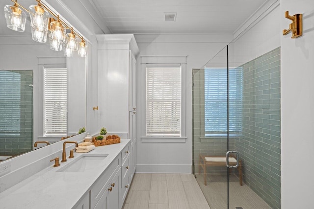 bathroom featuring vanity and a shower with shower door