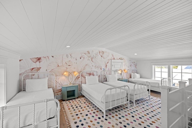 bedroom featuring vaulted ceiling, wood ceiling, and light hardwood / wood-style floors