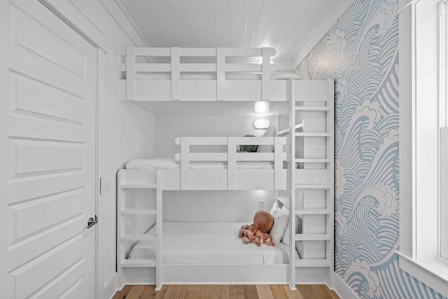 bedroom featuring light hardwood / wood-style flooring and crown molding