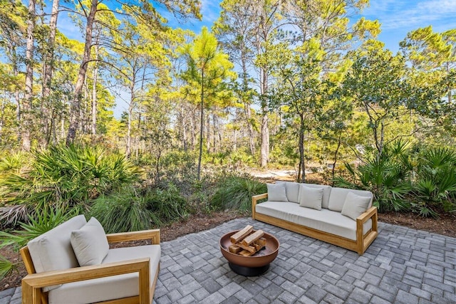 view of patio featuring an outdoor living space with a fire pit