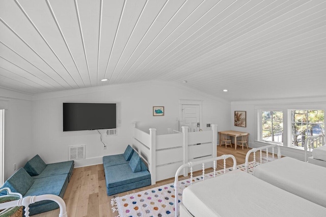 bedroom featuring light hardwood / wood-style floors, crown molding, vaulted ceiling, and wood ceiling