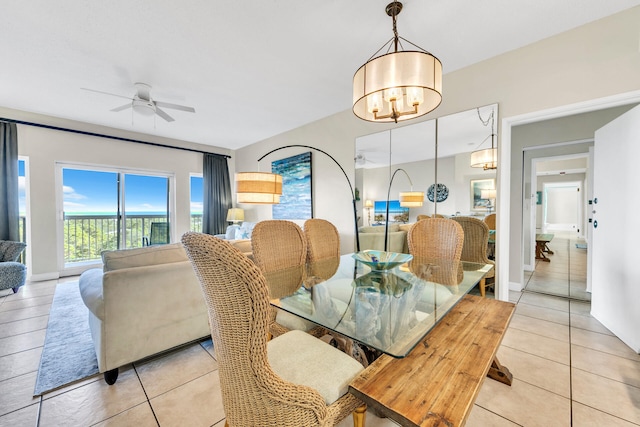 tiled dining space featuring ceiling fan with notable chandelier