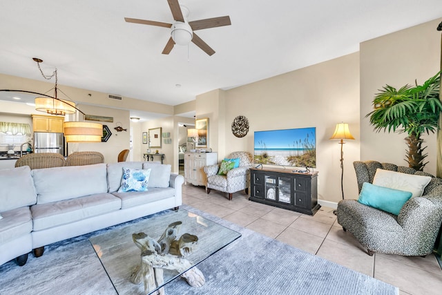 tiled living room with ceiling fan