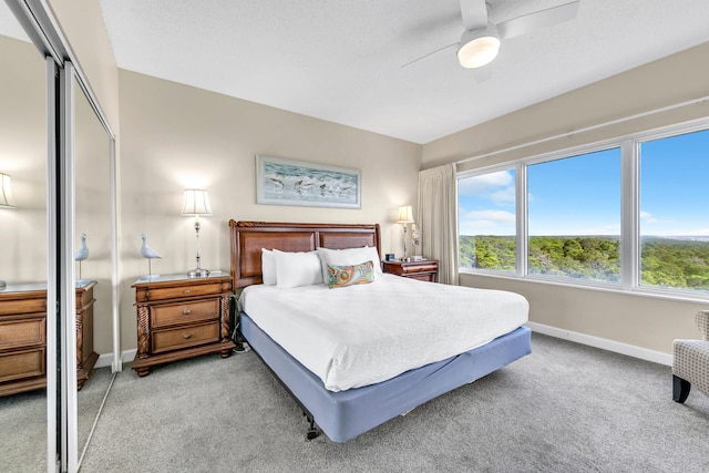 carpeted bedroom featuring a closet and ceiling fan