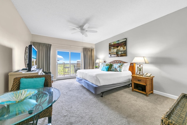 carpeted bedroom with a textured ceiling, access to exterior, and ceiling fan