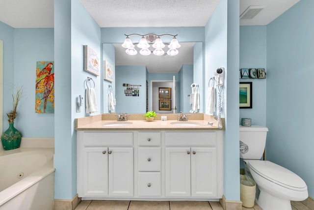 bathroom featuring a tub, a textured ceiling, toilet, tile patterned floors, and vanity