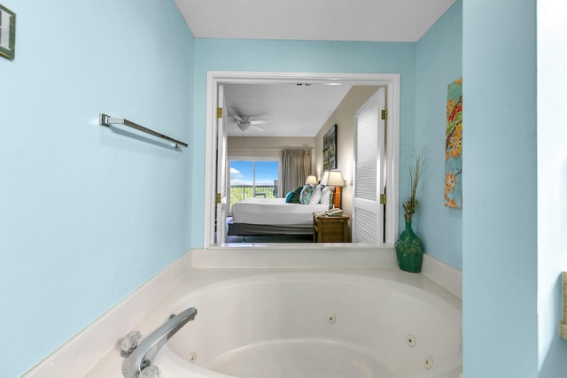 bathroom with a bath and ceiling fan